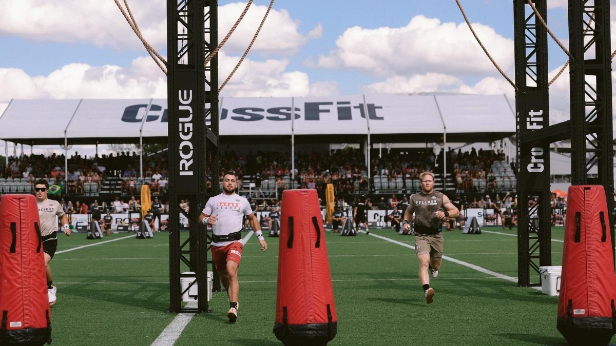 Ricky Garard and Patrick Vellner running on turf, outside, at the 2022 CrossFit Games.