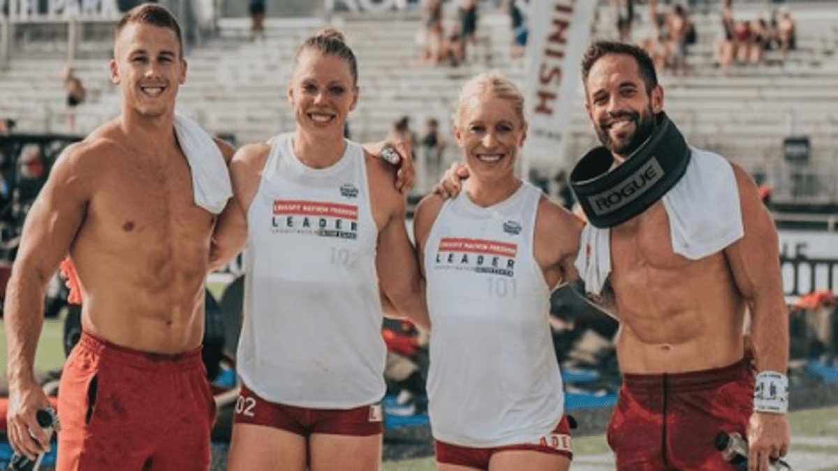 CrossFit Mayhem Freedom team members stand and smile at the camera.