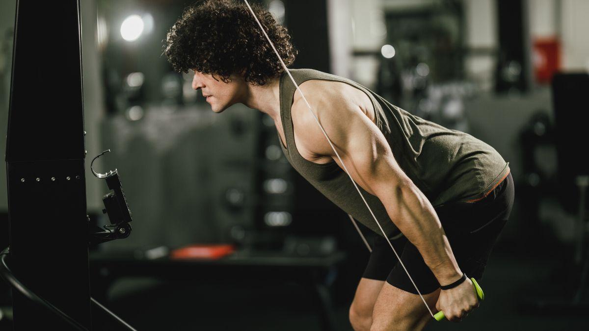 A closeup of a person on a ski erg machine.